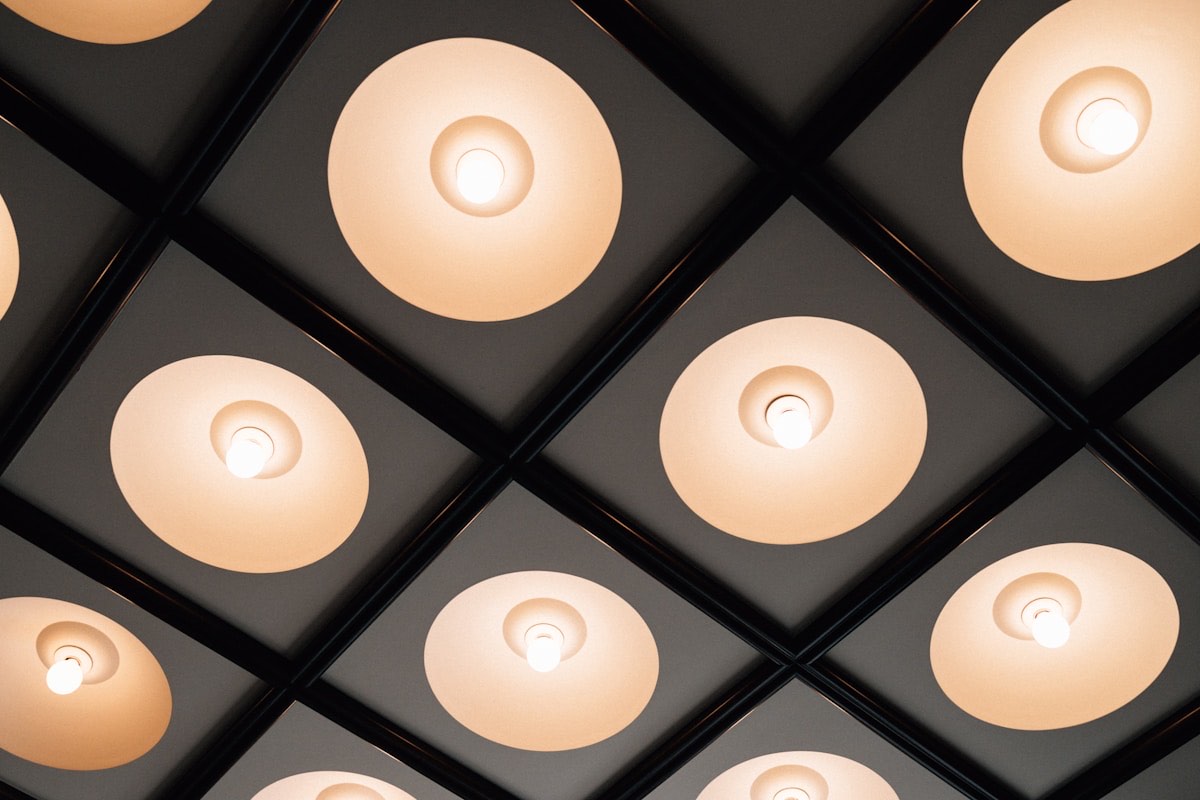 A ceiling of warm, evenly spaced pendant lights